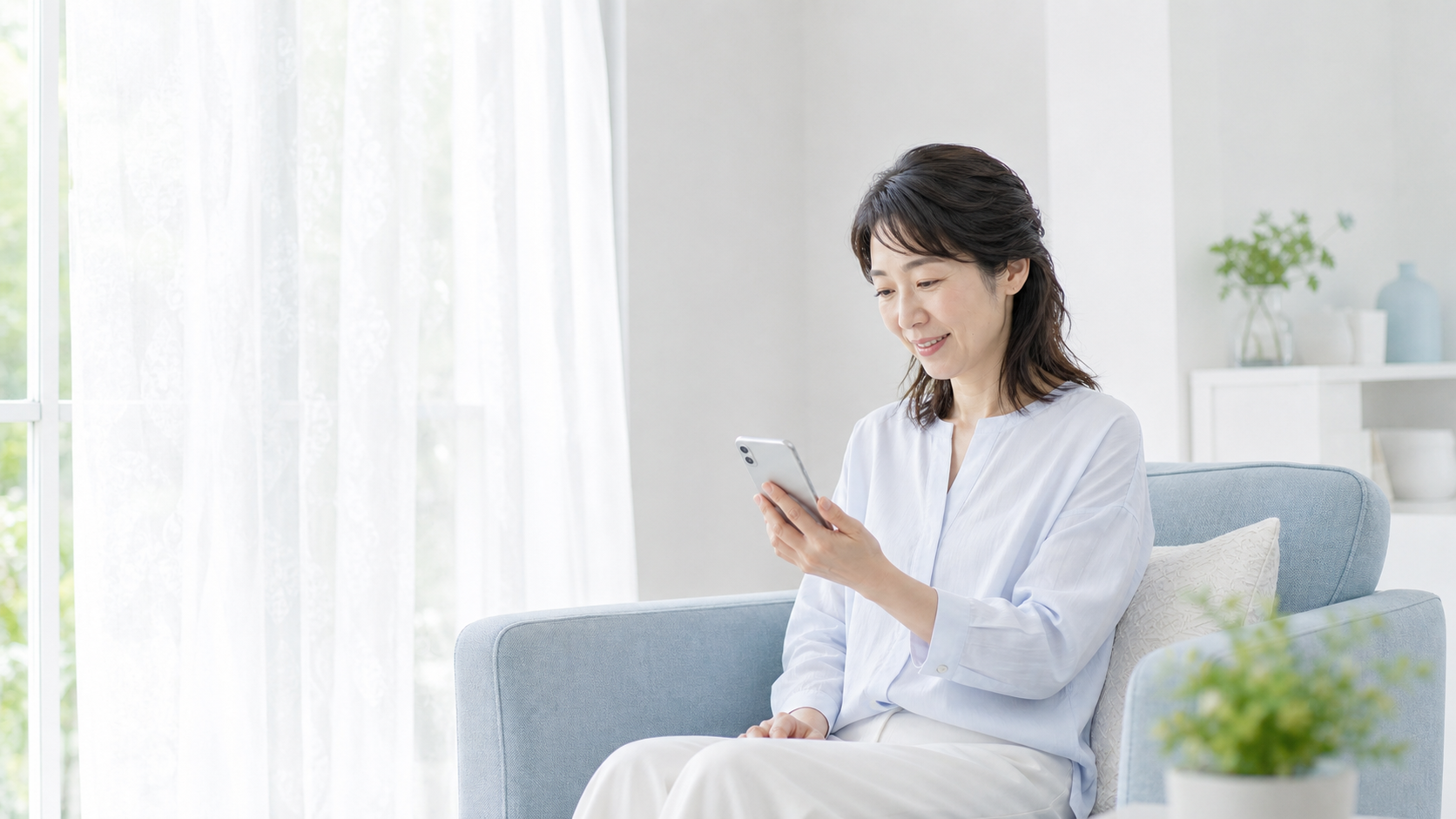 窓辺の明るいリビングでスマートフォンの設定を確認する日本人女性